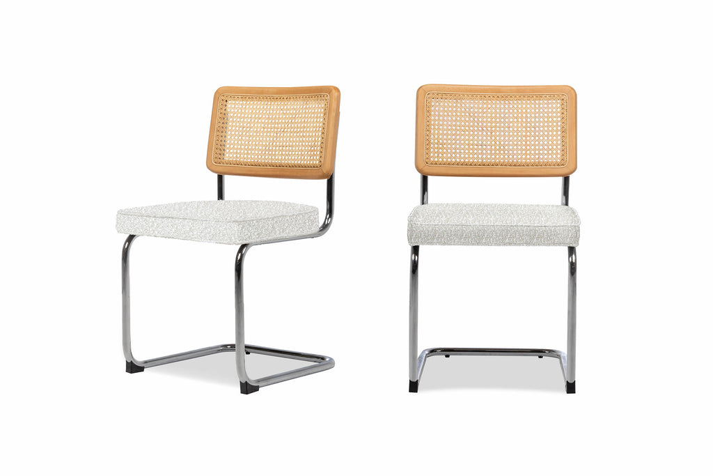 Set of two Nora dining chairs with the seat cushion upholstered in bouclé placed side by side 